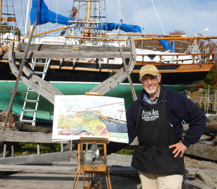 Man plein air painting boats at the Essex Shipbuilding Museum