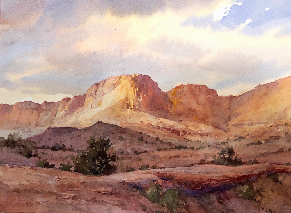 Watercolor painting of a sunlit ridge of red rocks
